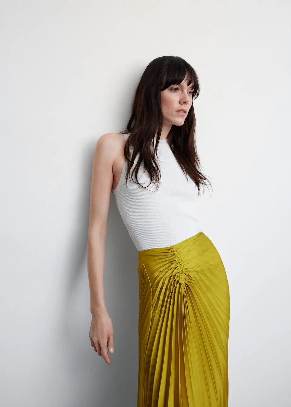 Pleated asymmetric skirt