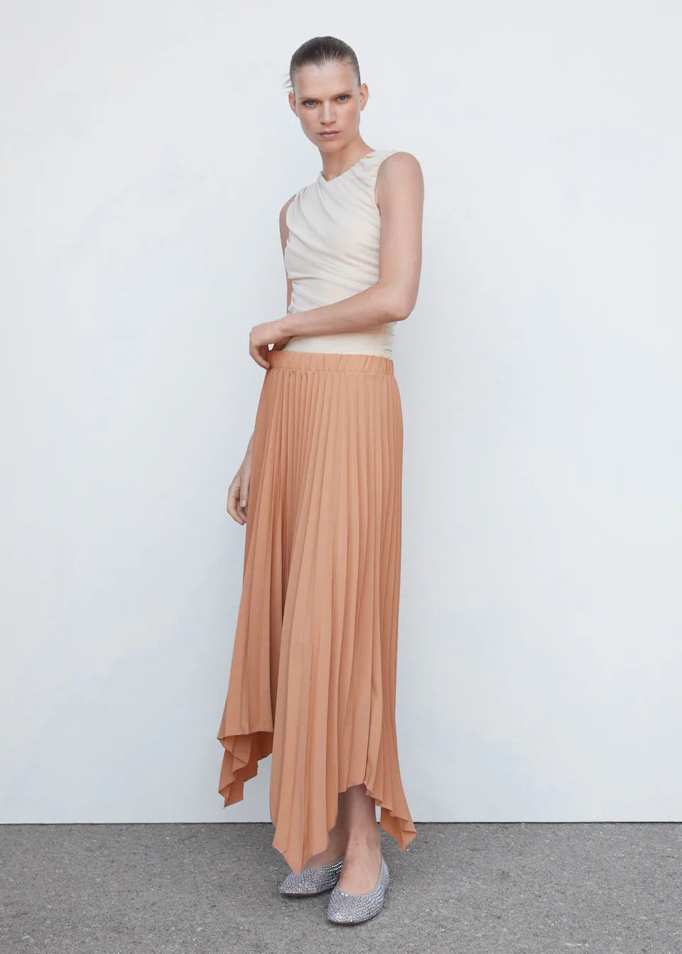 Pleated asymmetric skirt