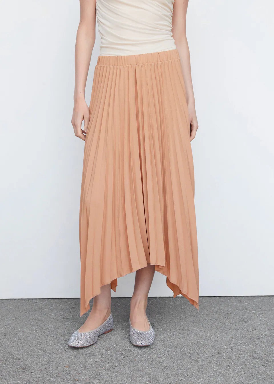 Pleated asymmetric skirt