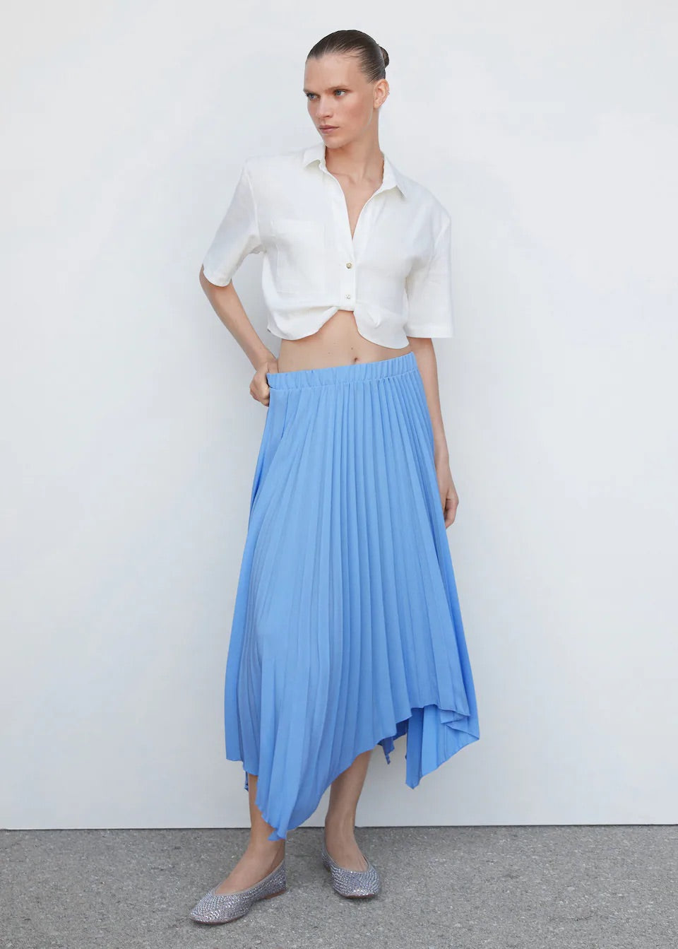 Pleated asymmetric skirt