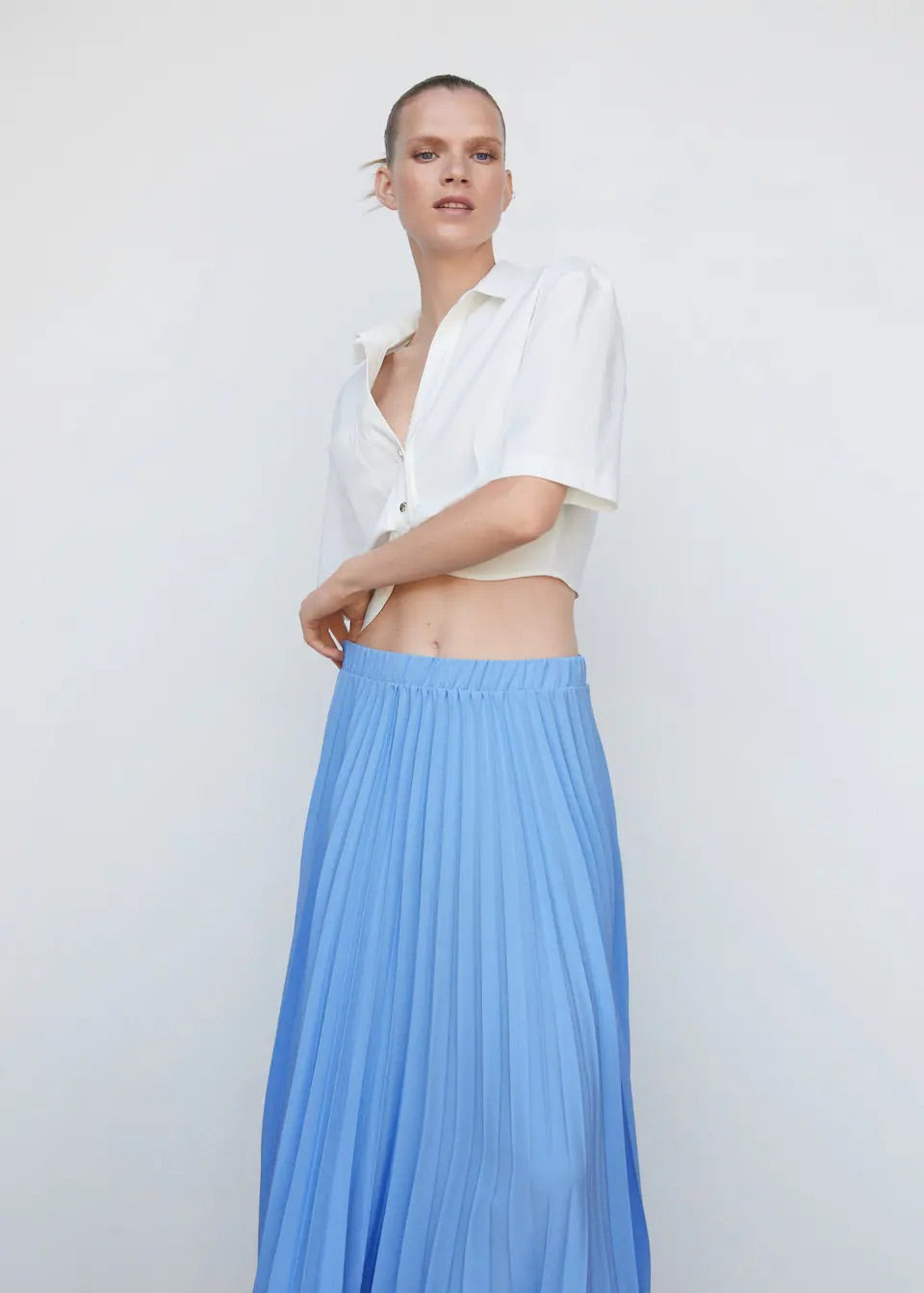 Pleated asymmetric skirt