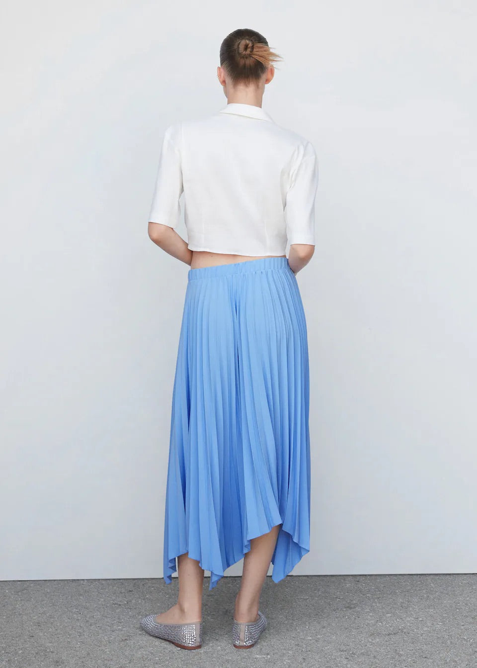 Pleated asymmetric skirt